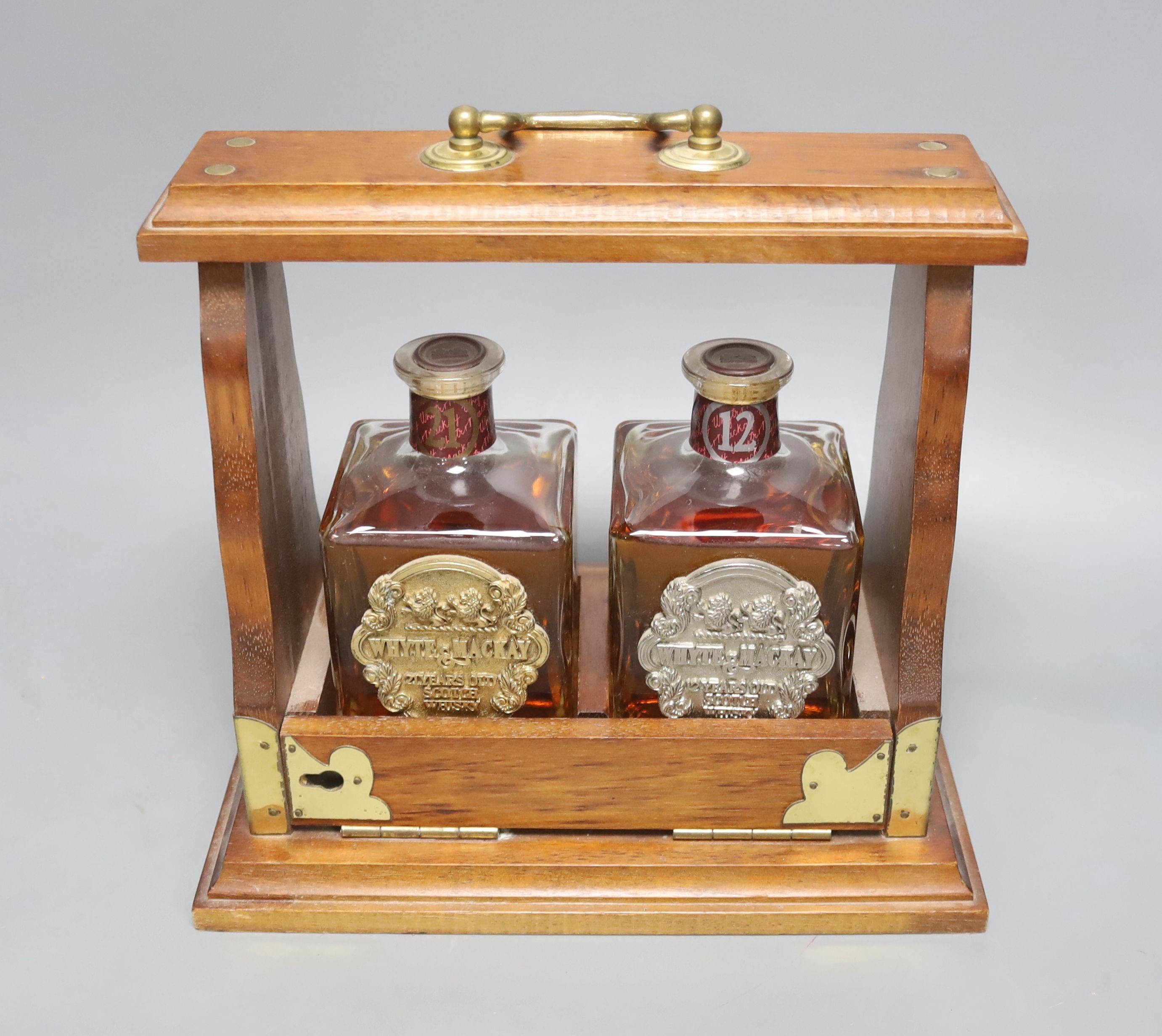 Tantalus containing White and Mockay 21 year and 12 year whiskey, 23 cms high.